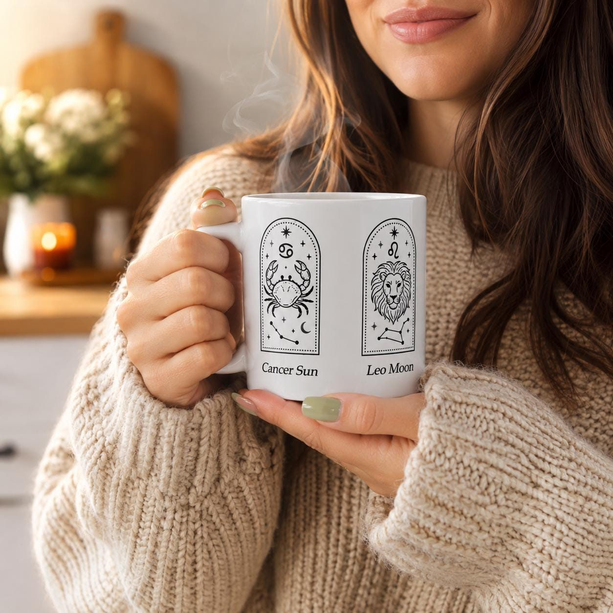 White ceramic mug with three zodiac arches in black line art, held in two hands