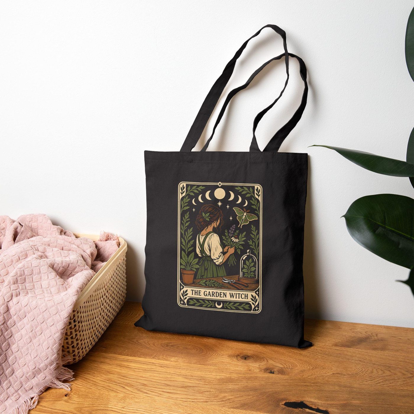 Black cotton canvas tote bag printed with a garden witch tarot card illustration